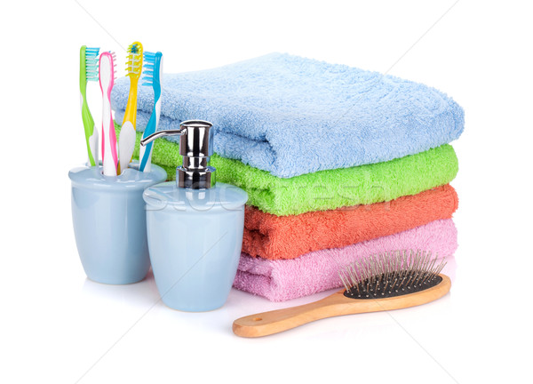 Four toothbrushes, liquid soap, hairbrush and colorful towels Stock photo © karandaev