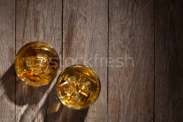 Stock photo: Glasses of whiskey with ice on wood
