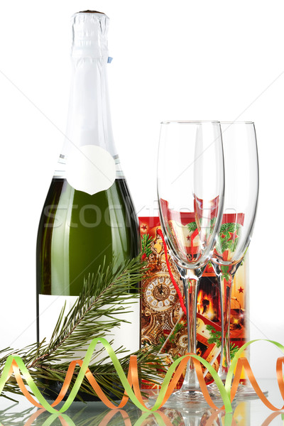 Stock photo: Bottle of champagne, two glasses and small gift