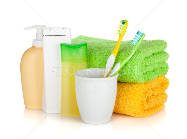 Two colorful toothbrushes, cosmetics bottles and towels Stock photo © karandaev