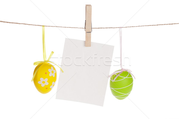 Colorful easter eggs and blank photo frame hanging on rope Stock photo © karandaev