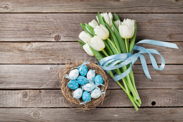 Easter eggs and white tulips Stock photo © karandaev