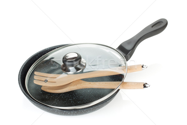 Frying pan with glass cover and wooden utensils Stock photo © karandaev