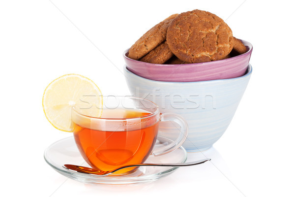 Glass cup of black tea with lemon and cookies Stock photo © karandaev