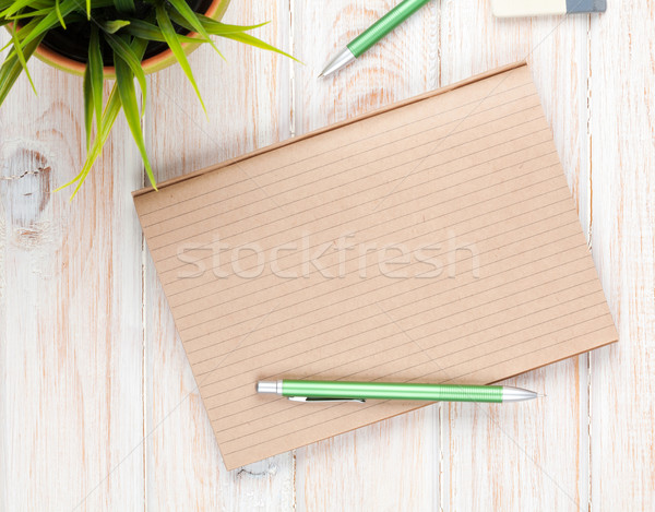 Office desk table with supplies and flower Stock photo © karandaev