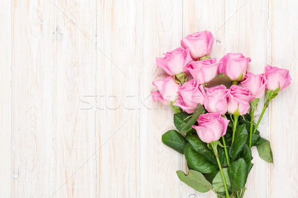 Pink roses bouquet over wooden table Stock photo © karandaev