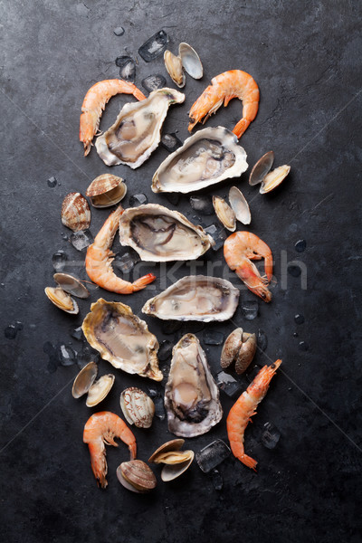 Fresh seafood on stone table Stock photo © karandaev