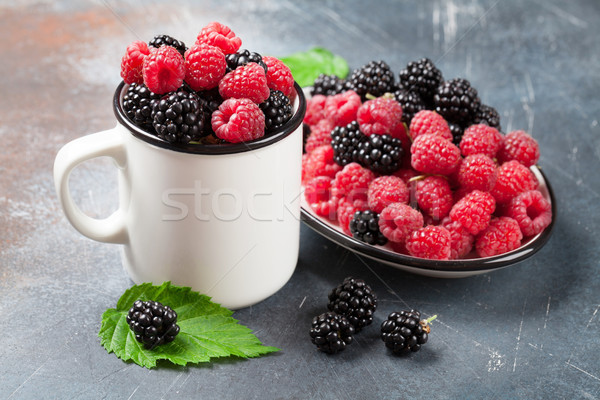 Cup of ripe blackberries and raspberries Stock photo © karandaev