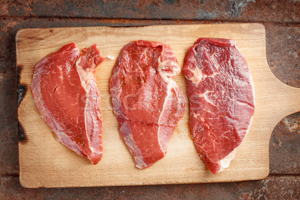 Raw beef steak on cutting board Stock photo © Karpenkovdenis