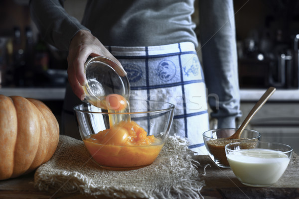 Adding eggs in the pumpkin puree in the glass bowl Stock photo © Karpenkovdenis