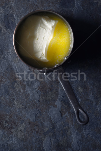 Melted butter in the stewpan on the stone background vertical Stock photo © Karpenkovdenis