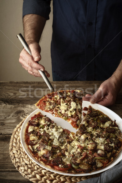 Pizza and a slice of pizza on a white dish Stock photo © Karpenkovdenis