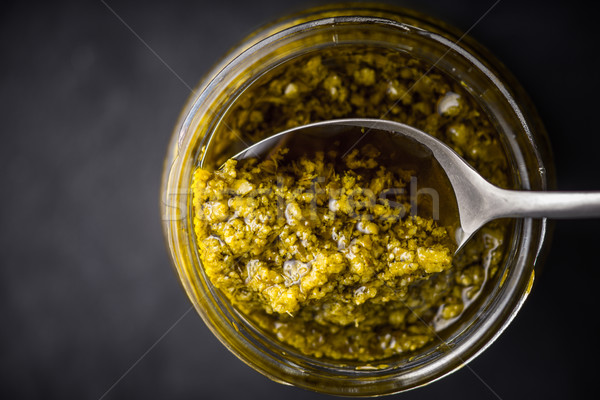 Pesto sauce in the glass jar with spoon top view Stock photo © Karpenkovdenis