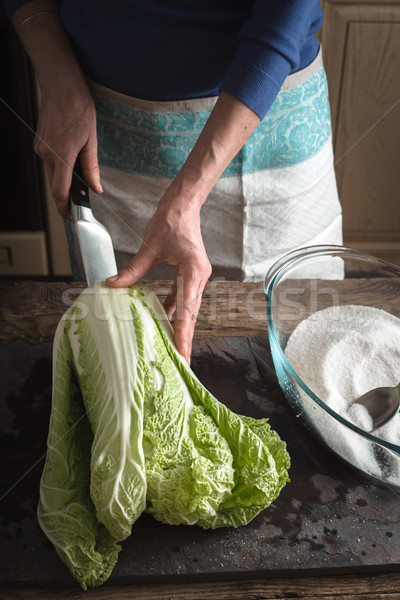 Woman cut Chinese cabbage to cook kimchi on slate Stock photo © Karpenkovdenis