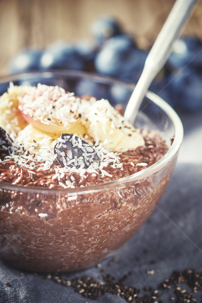 Chocolate chia pudding with fruits in the glass bowl Stock photo © Karpenkovdenis