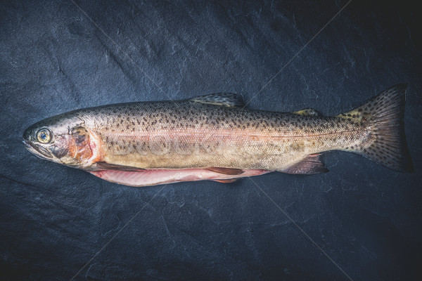 Raw trout on the dark stone background top view Stock photo © Karpenkovdenis