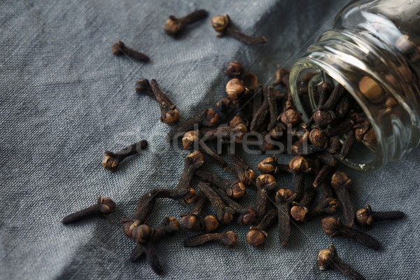 Cloves in the glass jar on the grey cloth Stock photo © Karpenkovdenis