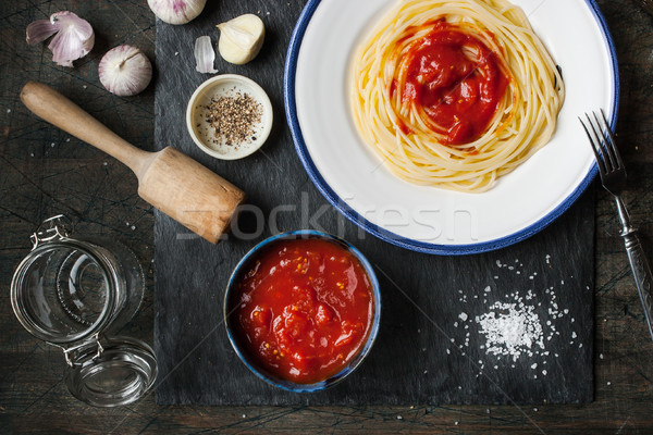 Pureed tomatoes in a ceramic dish and a plate with spaghetti on  Stock photo © Karpenkovdenis
