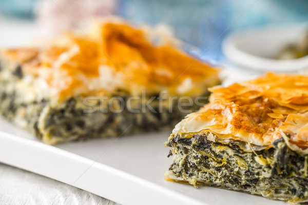 Greek pie spanakopita on the white plate with blurred accessorizes horizontal Stock photo © Karpenkovdenis