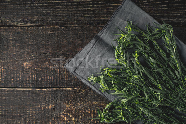 Tarragon on the grey napkin on the wooden table top view Stock photo © Karpenkovdenis