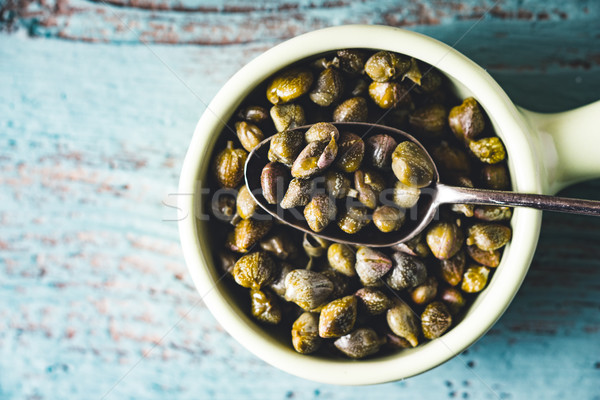 Capers in the bowl on the light blue background top view Stock photo © Karpenkovdenis