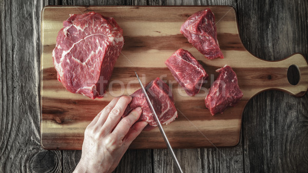 Cutting angus beef on the wooden table top view Stock photo © Karpenkovdenis