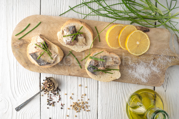 Sandwiches with sardines and onions on a cutting board Stock photo © Karpenkovdenis