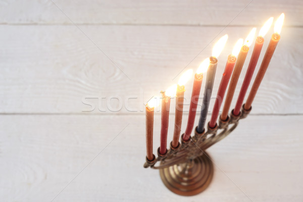 Hanukkah menorah with burning candles on the white wooden table Stock photo © Karpenkovdenis
