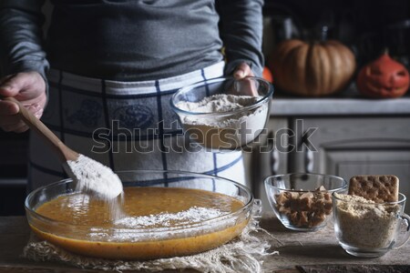 Stock photo: Dough for pumpkin dump cake in the baking dish on the wooden table