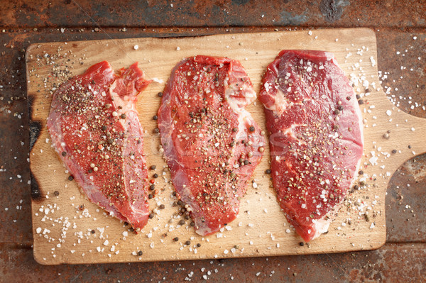 Raw beef steak and spicel on cutting board Stock photo © Karpenkovdenis