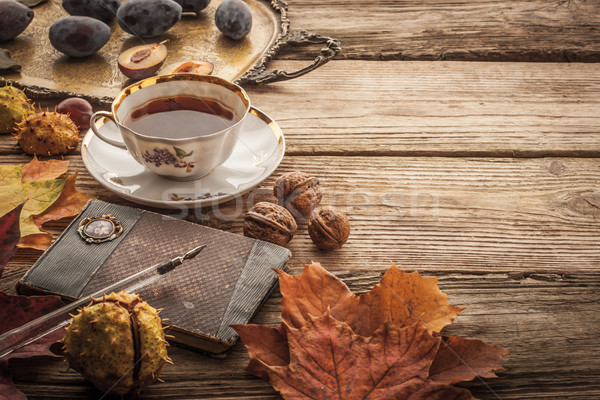 Plums , nuts and leaves with vintage notebook and tea with film  Stock photo © Karpenkovdenis