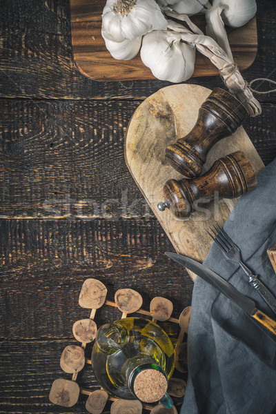 Garlic , olive oil and kitchen accessorize on the wooden table vertical Stock photo © Karpenkovdenis