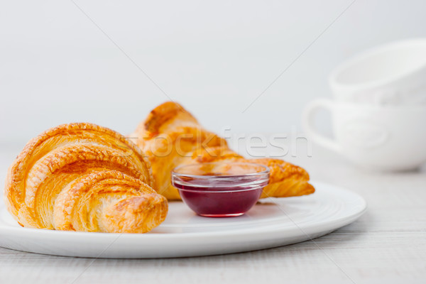 Croissants with berry jam and two white blurred cups horizontal Stock photo © Karpenkovdenis