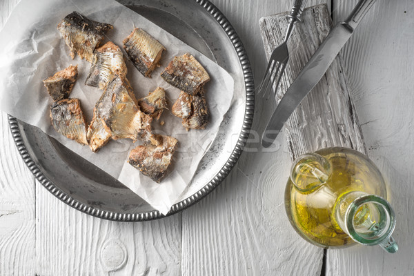 Plate with fish and olive oil on a wooden table Stock photo © Karpenkovdenis