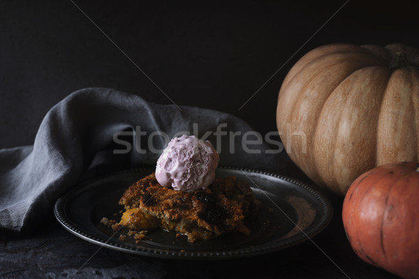 Pumpkin dump cake with ice cream on the metal plate on the stone table Stock photo © Karpenkovdenis