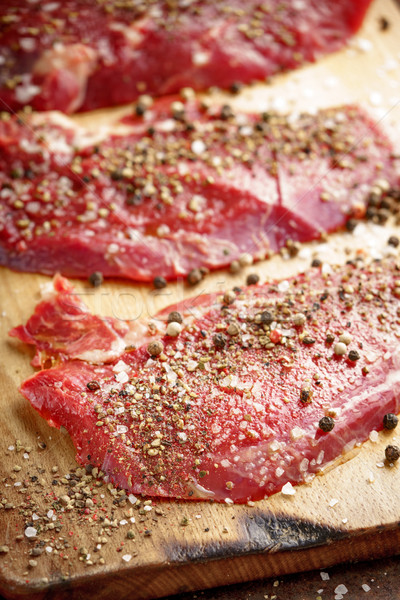 Raw beef steak and spicel on cutting board on the table Stock photo © Karpenkovdenis