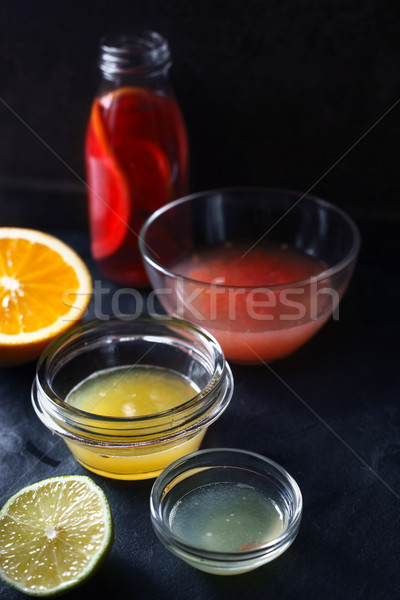 Citrus juice in the different glass bowl on the dark stone background Stock photo © Karpenkovdenis