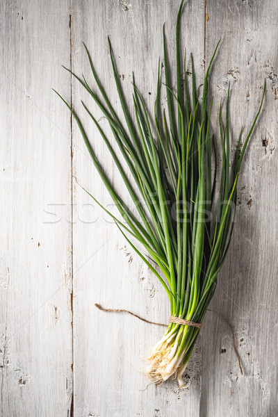 Green onion on the white wooden table top view Stock photo © Karpenkovdenis