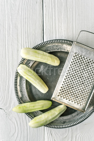 Peeled cucumbers in the metal plate with grater top view Stock photo © Karpenkovdenis