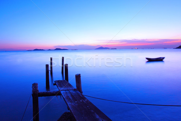 Sunset along a wooden pier at magic hour Stock photo © kawing921