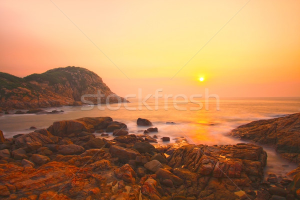 Sea stones along the coast at sunrise Stock photo © kawing921