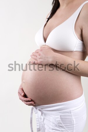Pregnant woman putting creme on her belly Stock photo © kb-photodesign