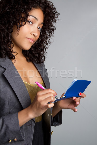 Kobieta piśmie sprawdzić piękna czarnej kobiety dziewczyna Zdjęcia stock © keeweeboy