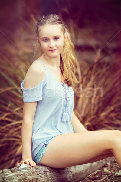 Blond teen girl posiedzenia dziewczyna uśmiech charakter Zdjęcia stock © keeweeboy