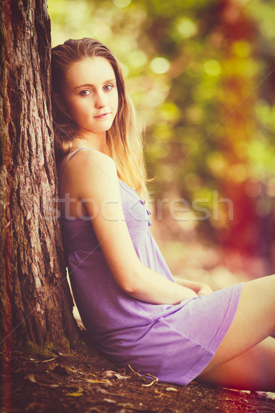 Girl Sitting by Tree Stock photo © keeweeboy