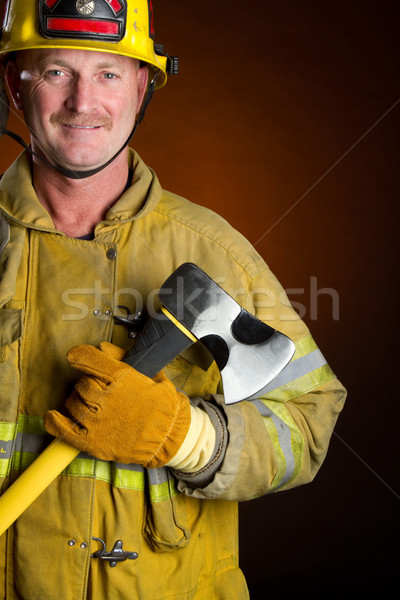 Lächelnd Feuerwehrmann halten ax Mann Hintergrund Stock foto © keeweeboy