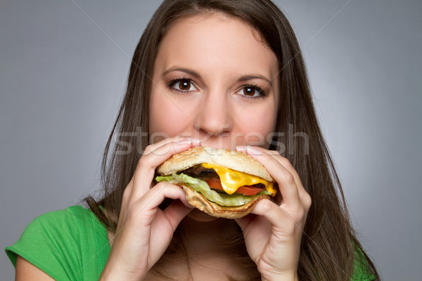 Fată mananca hamburger fata frumoasa alimente faţă Imagine de stoc © keeweeboy