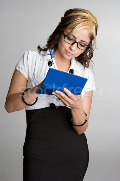 Zakenvrouw schrijven controleren latino boek pen Stockfoto © keeweeboy