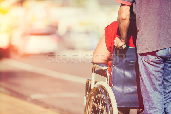 Man Pushing Wheelchair Stock photo © keeweeboy