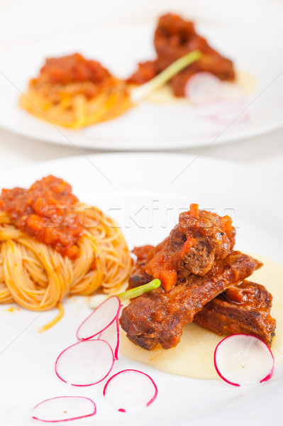 pasta with pork ribs sauce on polenta bed Stock photo © keko64